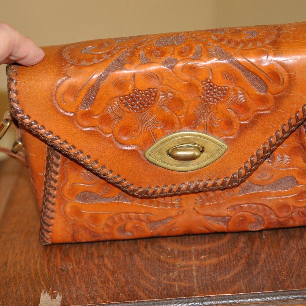 Vintage hand tooled 1950 leather purse with long adjustable handle.